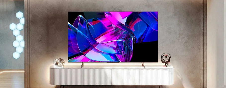 Modern living room with a large TV on a sleek white console. The screen displays vibrant abstract art in pink and blue. Stylish, minimal decor.