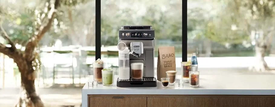 Elegant coffee station with a sleek espresso machine, various coffee drinks, and a paper bag. Sunlit window view enhances the inviting atmosphere.