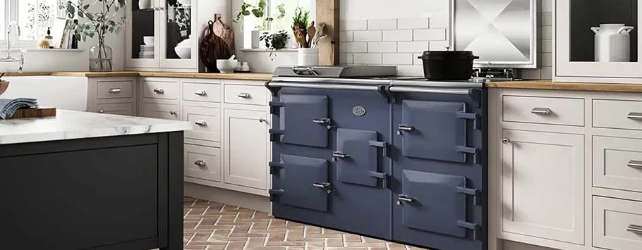 Modern kitchen with a blue vintage-style stove, white cabinetry, wooden countertops, and green plants. The ambiance is bright and inviting.