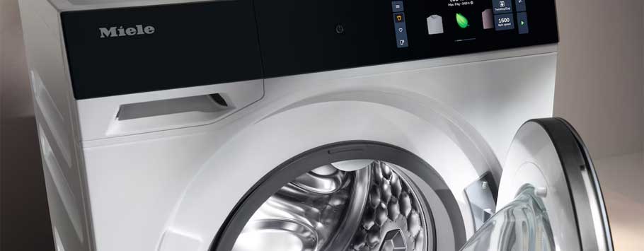 Modern Miele washing machine with an open glass door, sleek white design, and digital display, conveying a sense of cleanliness and efficiency.