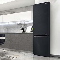 Sleek black refrigerator in modern kitchen with marble countertops and minimalist design. Neutral tones create a calm and sophisticated atmosphere.