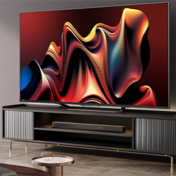 A large TV displaying colourful abstract waves in shades of red, orange, and blue is mounted on a sleek modern stand, creating a vibrant, artistic ambiance.