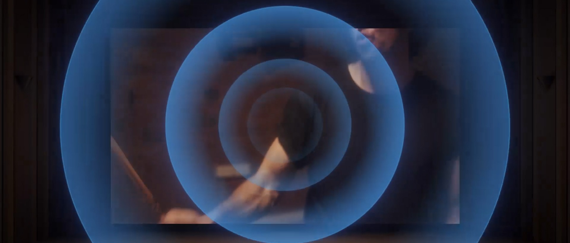 Close-up of a drummer’s hand, followed by a cinema scene with sound waves radiating outward, illustrating BRAVIA 5’s immersive, side-mounted speakers.