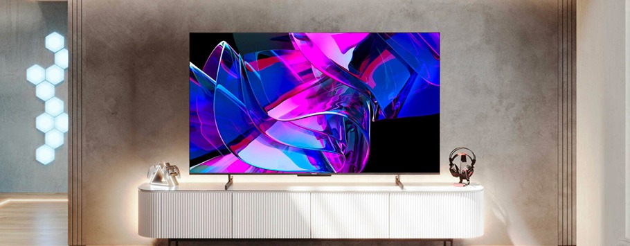 Modern living room with a large TV on a sleek white console. The screen displays vibrant abstract art in pink and blue. Stylish, minimal decor.