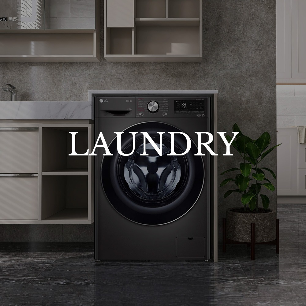 Modern laundry room with a black front-load washing machine below open shelves. A green plant stands beside it, and "Laundry" is overlaid in bold text.