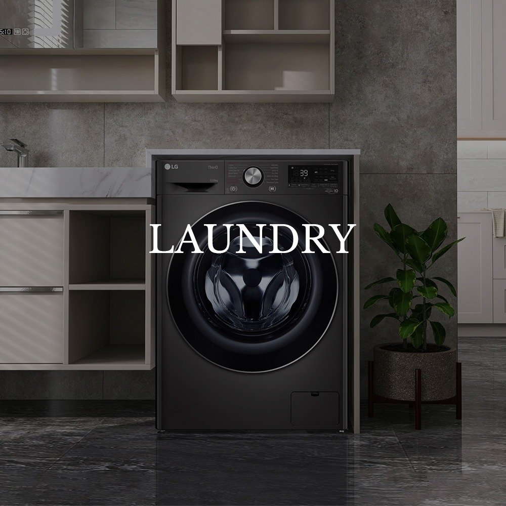 Modern laundry room with a black front-load washing machine below open shelves. A green plant stands beside it, and "Laundry" is overlaid in bold text.