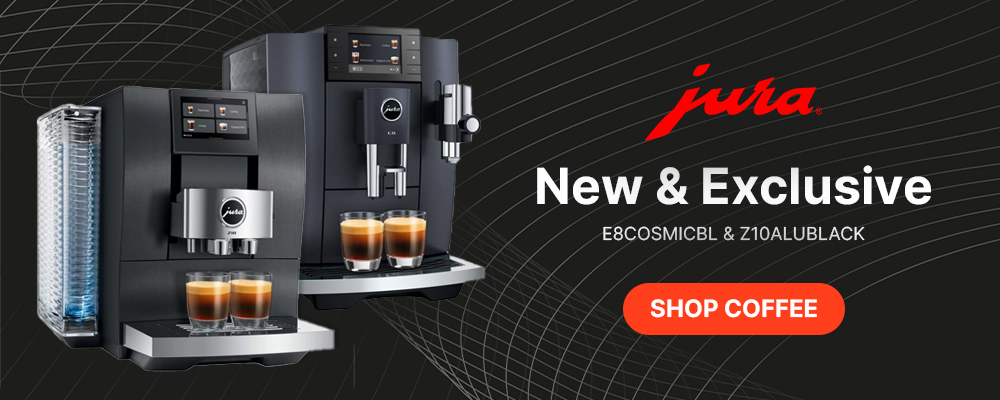 Two sleek, black Jura coffee machines with cups on metal trays. Bold text reads "New & Exclusive," with an orange "Shop Coffee" button. Energetic, modern feel.