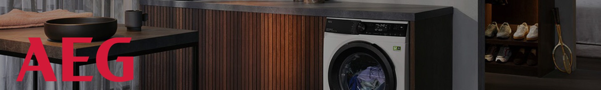 A person in a kitchen pulls fresh pasta from a red KitchenAid mixer with an attachment.