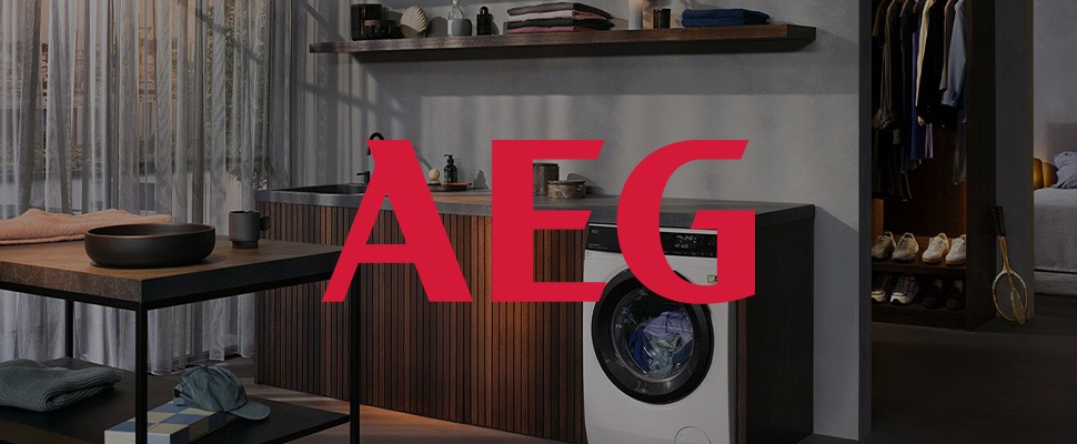 A person in a kitchen pulls fresh pasta from a red KitchenAid mixer with an attachment.