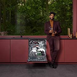 A sleek black stand mixer with a large wooden bowl sits on a kitchen countertop.