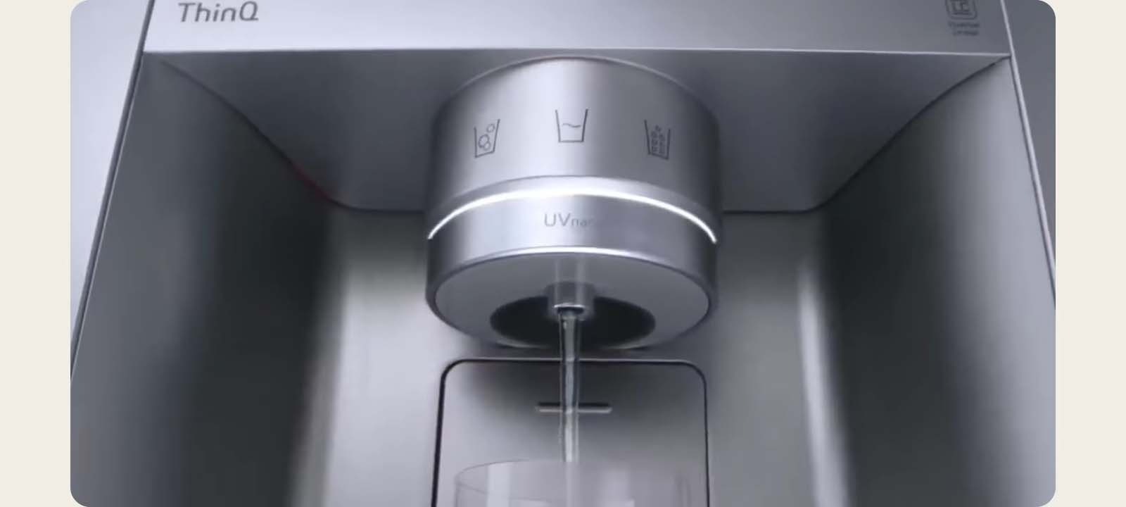 The water is coming out of the dispenser in the black refrigerator.